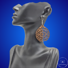 une paire de boucles d'oreilles en bois gravées au laser, avec un crochet en argent et un motif décoratif en métal. Très légères